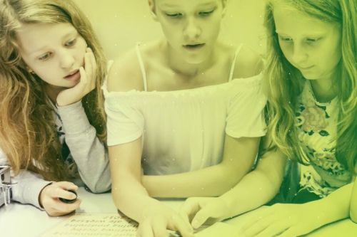 trzy dziewczyny w wieku około 8 lat patrzące w jednym kierunku