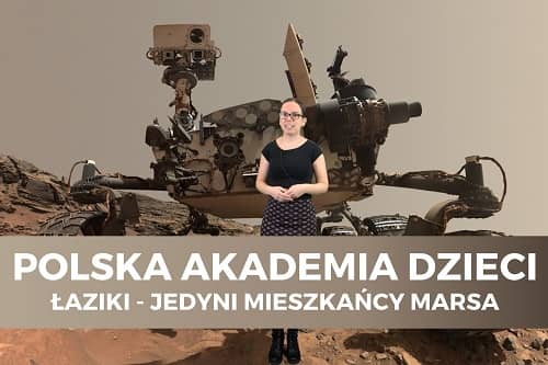 Miniaturka filmu z cyklu Polska Akademia Dzieci pt. Łaziki - jedyni mieszkańcy Marsa. Na zdjęciu kobieta na tle łazika marsjańskiego.