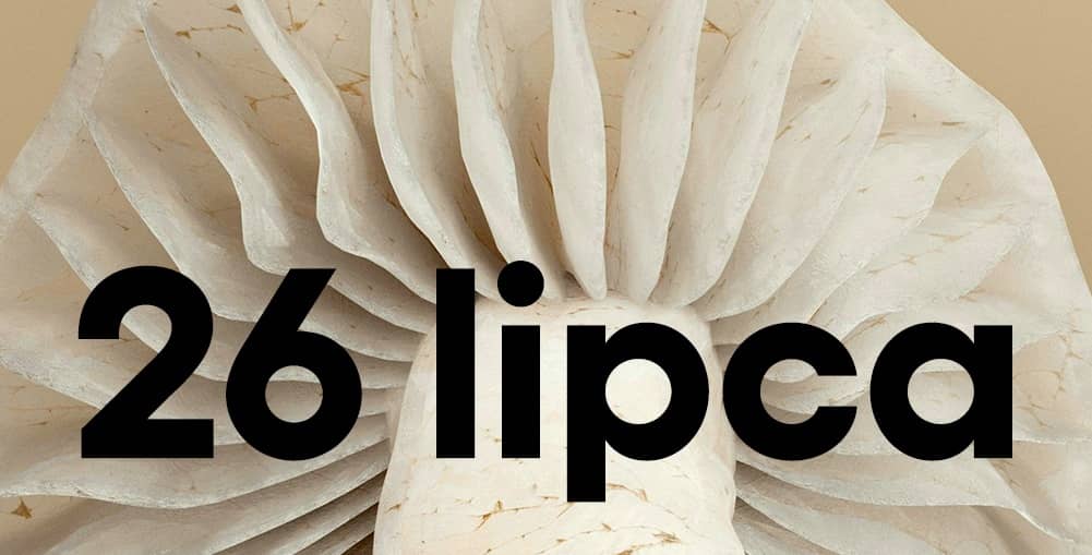 Zbliżenie na jasny kapelusz grzyba od spodu z wyraźnie widocznymi blaszkami. Na środku napis: „26 lipca”.